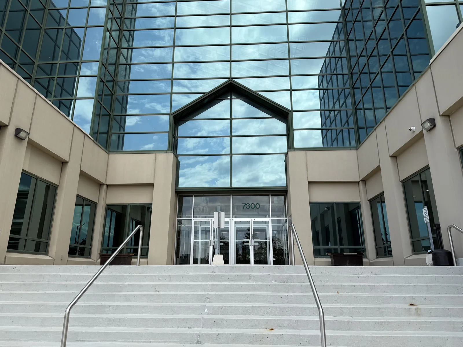 The exterior of 7300, the office building in Markham that houses Artistry Clinic, seen from the front steps.